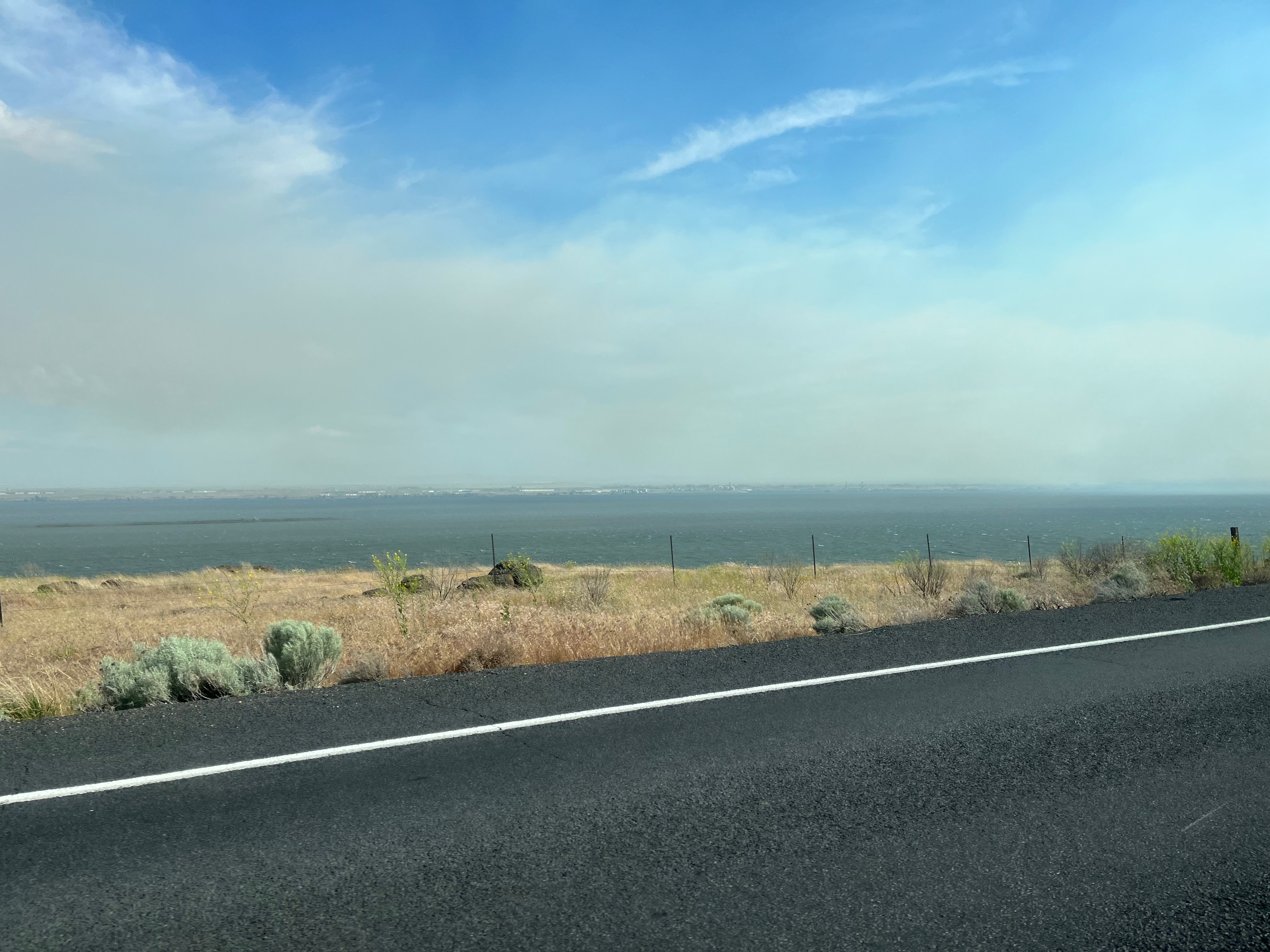 Photo of smoke engulfing an interstate from a highway across a river.